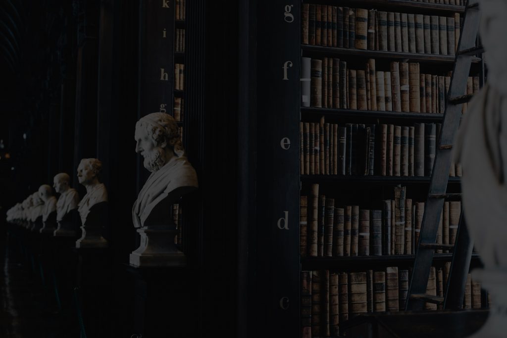 busts and books in a dark library